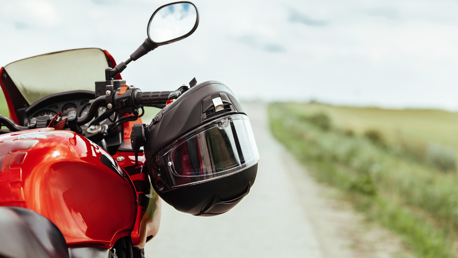 A red motorcycle on a road.