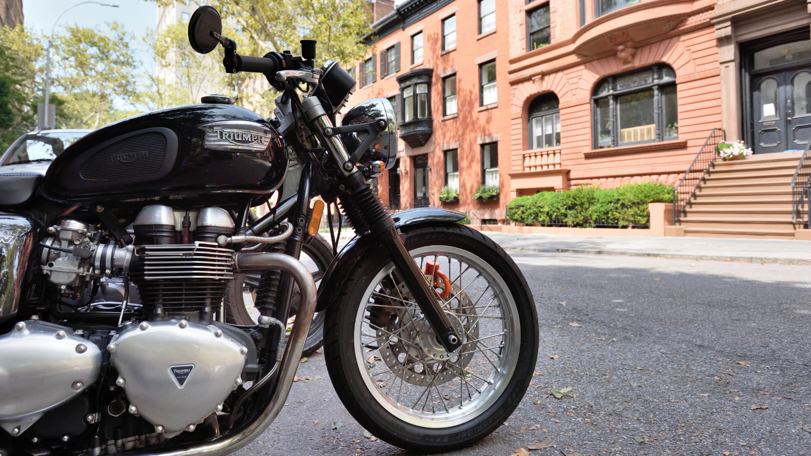 A motorcycle parked on a road in a city.