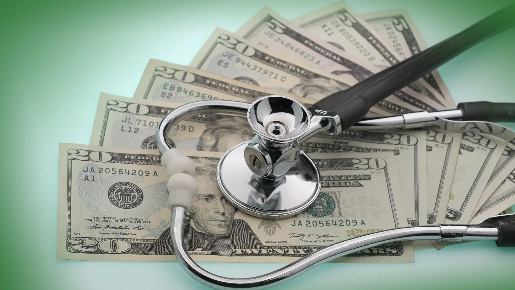 $20 bills and stethoscope describe the US healthcare system