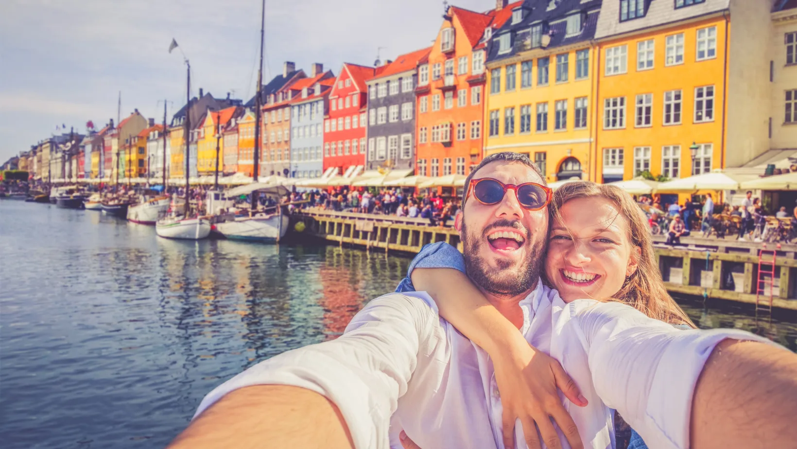 Couple takes a selfie in the Nyhavn district of Copenhagen, Denmark
