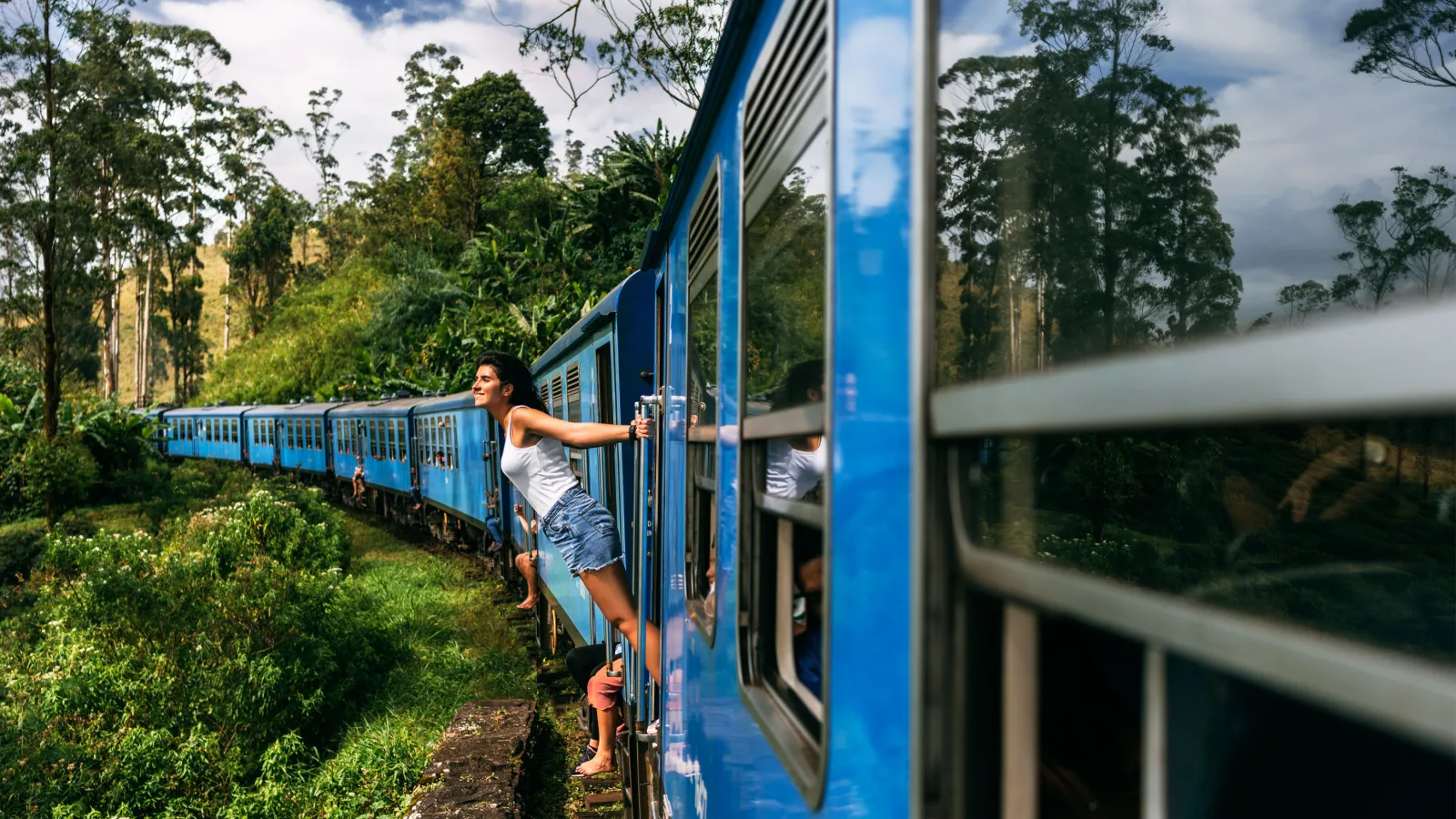 A woman hanging off of a train.